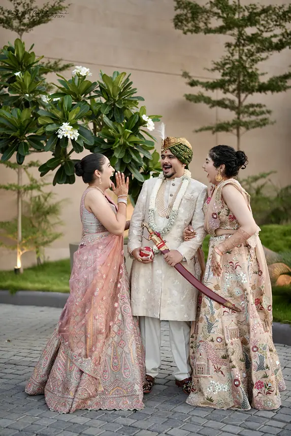 Groom with the bride and family in pastel outfits