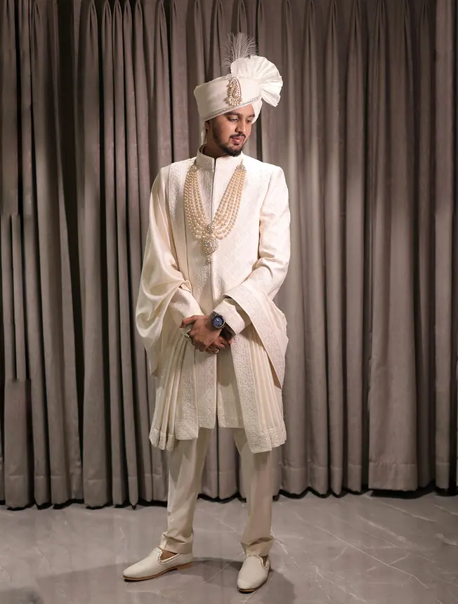 Groom in ivory sherwani and white safa, full length