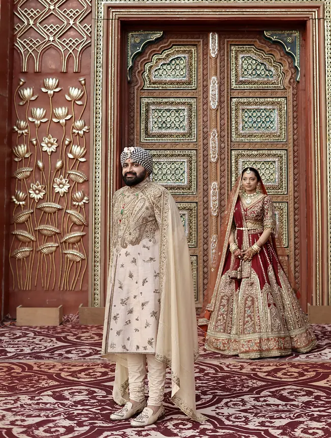 Couple at an ornate carved door