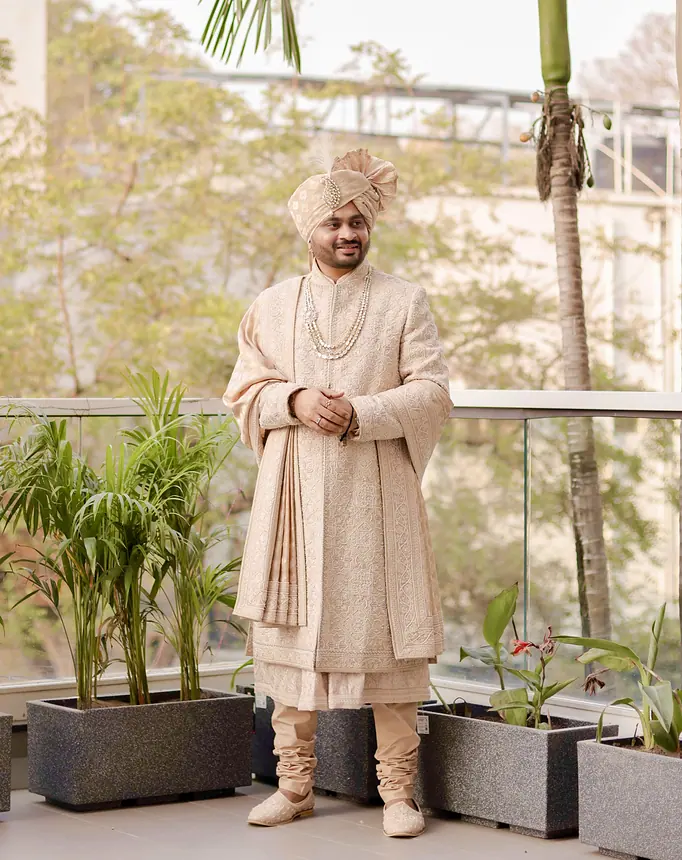 Groom in ivory sherwani on a terrace