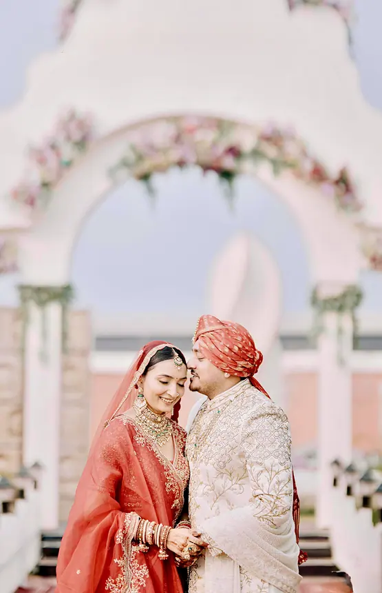 Couple under a floral arch