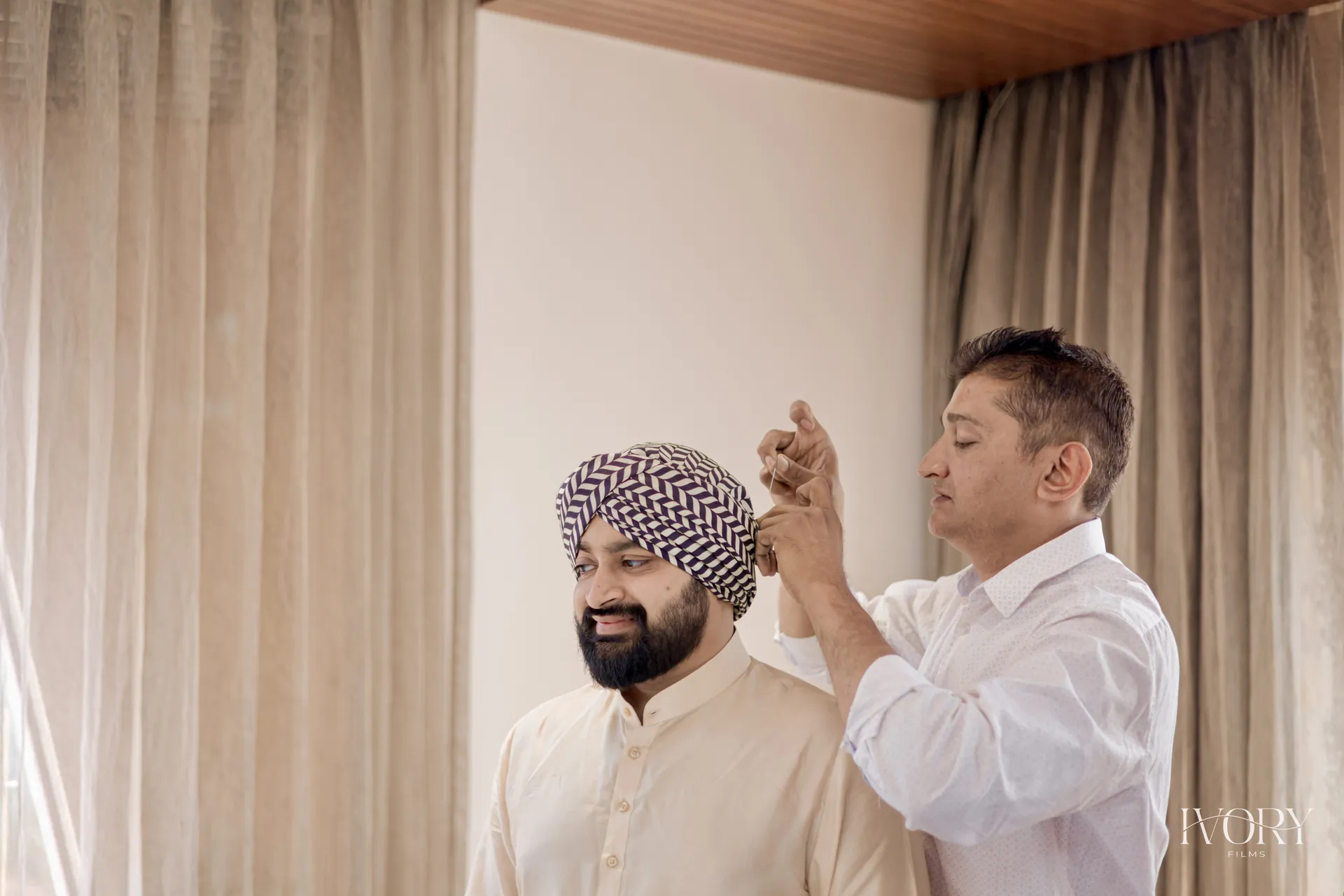 Kishore adjusting a groom's turban