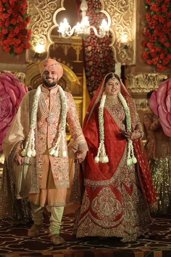 Groom and bride entering with garlands